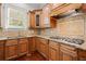A well-appointed kitchen showcases granite countertops and matching brown wood cabinetry at 980 Pine Grove Rd, Roswell, GA 30075