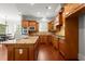 Kitchen features dark wood cabinets, granite countertops, stainless appliances, and hardwood floors at 980 Pine Grove Rd, Roswell, GA 30075