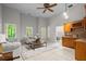 Open-concept living room with large windows, a comfortable sofa, and a cozy atmosphere at 980 Pine Grove Rd, Roswell, GA 30075