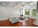 Bright living room featuring a coffered ceiling, hardwood floors, and large windows overlooking the wooded outdoors at 980 Pine Grove Rd, Roswell, GA 30075
