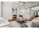 Bright living room featuring a stone fireplace, neutral furniture, hardwood floors, and open floorplan at 980 Pine Grove Rd, Roswell, GA 30075