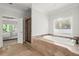 The bathtub is elegantly positioned with tile steps leading up to the soaking tub at 980 Pine Grove Rd, Roswell, GA 30075