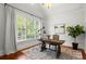 Bright, cozy home office with a large window, desk, and natural light at 980 Pine Grove Rd, Roswell, GA 30075