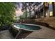 Inviting backyard pool featuring elegant stonework and a lush, private setting at 980 Pine Grove Rd, Roswell, GA 30075