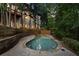 Backyard pool area with natural stone accents, and multilevel wooden deck at 980 Pine Grove Rd, Roswell, GA 30075