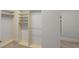 Spacious walk-in closet boasts built-in shelving and ample hanging space for optimal organization at 980 Pine Grove Rd, Roswell, GA 30075