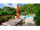 Expansive backyard with patio dining, lush landscaping, mature trees, and a lovely swimming pool at 102 Cavit Ct, Canton, GA 30114