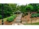 Beautiful tiered backyard with stone steps leading to an inviting in-ground pool at 102 Cavit Ct, Canton, GA 30114