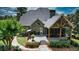 Private backyard featuring a screened in porch, deck, professional landscaping, and stone walkway at 102 Cavit Ct, Canton, GA 30114