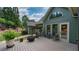 Deck area with outdoor seating, fire pit, and views of lush greenery at 102 Cavit Ct, Canton, GA 30114