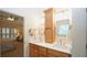 Bright bathroom with double sinks, wood cabinets, white countertop, and separate toilet closet at 102 Cavit Ct, Canton, GA 30114