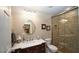 Bathroom with marble countertop, walk-in shower, and framed mirror at 102 Cavit Ct, Canton, GA 30114