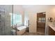 Bright bathroom with a modern tub and glass walk-in shower, and bedroom access at 102 Cavit Ct, Canton, GA 30114