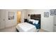 Bedroom featuring a wood-slat headboard, two closets, and wall art at 102 Cavit Ct, Canton, GA 30114