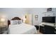Bedroom with a desk, a bed with white and blue bedding, and a side table with lamp at 102 Cavit Ct, Canton, GA 30114