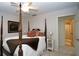 Bright bedroom with a four-poster bed, ceiling fan, and ensuite bathroom at 102 Cavit Ct, Canton, GA 30114