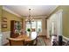 Formal dining room with hardwood floors, natural light, wainscoting, and views into the open living spaces at 102 Cavit Ct, Canton, GA 30114