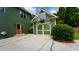 Home exterior featuring garage with basketball hoop, mature landscaping, and a side entrance at 102 Cavit Ct, Canton, GA 30114