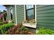 Charming exterior with flower boxes under the windows and lush green landscaping at 102 Cavit Ct, Canton, GA 30114