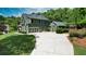 Spacious home featuring a long driveway, a well-maintained lawn, basketball hoop, and multiple car garage at 102 Cavit Ct, Canton, GA 30114
