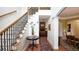 Home foyer boasting wood flooring, staircase with iron spindles, and an open view of the living spaces at 102 Cavit Ct, Canton, GA 30114