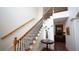 Home foyer boasting wood flooring, staircase with iron spindles, and an open view of the living spaces at 102 Cavit Ct, Canton, GA 30114