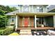 Charming covered front porch with stone accents and rocking chairs for relaxing outside at 102 Cavit Ct, Canton, GA 30114