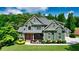 Charming two-story home with landscaped front yard and welcoming entrance, complemented by mature trees and lush greenery at 102 Cavit Ct, Canton, GA 30114