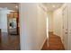 Hallway view that leads to the kitchen with stainless steel appliances and light wood cabinets at 102 Cavit Ct, Canton, GA 30114