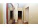 Hallway with wood flooring and decorative mirror and doorway to home theater at 102 Cavit Ct, Canton, GA 30114