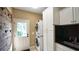 Functional laundry room featuring stacked washer and dryer, storage cabinets, and a sink at 102 Cavit Ct, Canton, GA 30114
