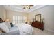 Bedroom with neutral decor, tray ceiling, plantation shutters, and furniture at 102 Cavit Ct, Canton, GA 30114