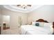 Bedroom featuring tray ceiling, large windows, and ensuite bathroom at 102 Cavit Ct, Canton, GA 30114