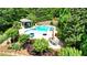Aerial view of a private pool, with a cabana, spa and ample seating surrounded by lush greenery and mature landscaping at 102 Cavit Ct, Canton, GA 30114