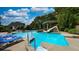 Beautiful swimming pool with water slide, hot tub, lounge chairs, and mature landscaping at 102 Cavit Ct, Canton, GA 30114