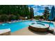Backyard pool and spa with lounge chairs and a blue umbrella at 102 Cavit Ct, Canton, GA 30114