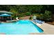Beautiful backyard pool with a slide, lounge chairs, and a basketball hoop for summer fun at 102 Cavit Ct, Canton, GA 30114