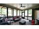 Charming screened-in porch with a ceiling fan and outdoor furniture at 102 Cavit Ct, Canton, GA 30114