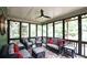 Cozy screened-in porch with comfortable seating, decorative rug, and ceiling fan at 102 Cavit Ct, Canton, GA 30114