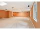 Large basement with carpet, recessed lighting, and multiple windows offering natural light at 10660 Dunoon Dr, Alpharetta, GA 30022
