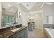 This spacious bathroom features dual sinks with granite counters, a soaking tub, and ample natural light at 10660 Dunoon Dr, Alpharetta, GA 30022
