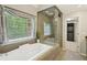 The primary bathroom includes a glass enclosed shower, soaking tub, and walk-in closet at 10660 Dunoon Dr, Alpharetta, GA 30022