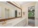 A full bathroom is attached to the bedroom and features a large mirror and double sink vanity at 10660 Dunoon Dr, Alpharetta, GA 30022