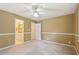 The bedroom features tan walls, neutral carpeting, a ceiling fan, and is attached to the bathroom at 10660 Dunoon Dr, Alpharetta, GA 30022