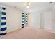Bright bedroom with pink carpet, white walls, and blue-striped curtains at 10660 Dunoon Dr, Alpharetta, GA 30022