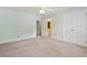 A bedroom includes a ceiling fan and doors to a closet and the attached bathroom at 10660 Dunoon Dr, Alpharetta, GA 30022