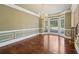 Dining room features hardwood floors, chandelier, bay window, and crown molding at 10660 Dunoon Dr, Alpharetta, GA 30022
