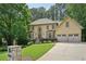 Stunning two-story home featuring a well-manicured lawn, a three-car garage, and a classic design at 10660 Dunoon Dr, Alpharetta, GA 30022