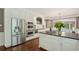 An open kitchen with custom cabinets, stainless appliances, and a view of the open concept living area at 10660 Dunoon Dr, Alpharetta, GA 30022