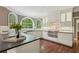 An open kitchen with custom cabinets, arched windows, stainless appliances, and dark countertops at 10660 Dunoon Dr, Alpharetta, GA 30022